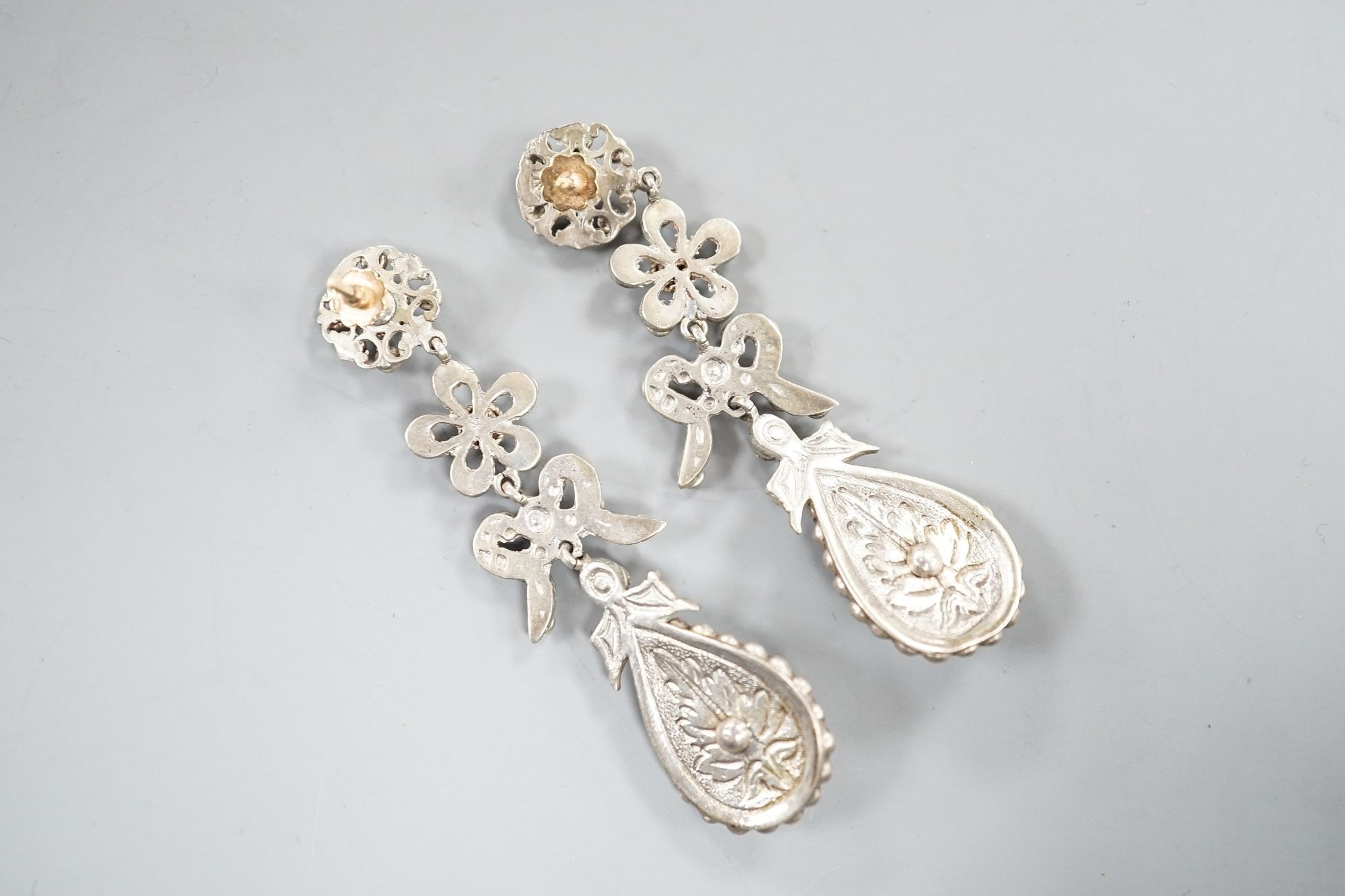 A pair of white metal and two colour paste drop earrings, 68mm, in a gilt tooled leather box.